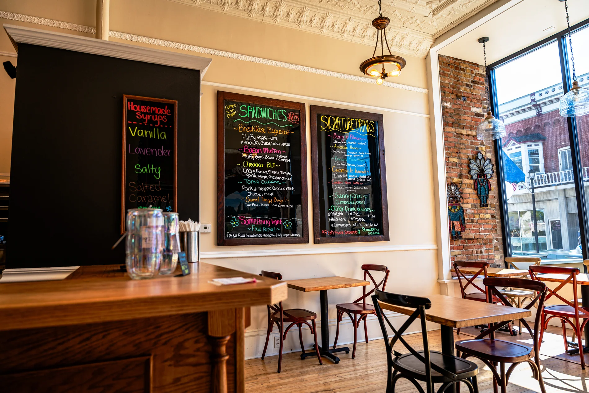 Tables and chalkboard menus inside The Counter