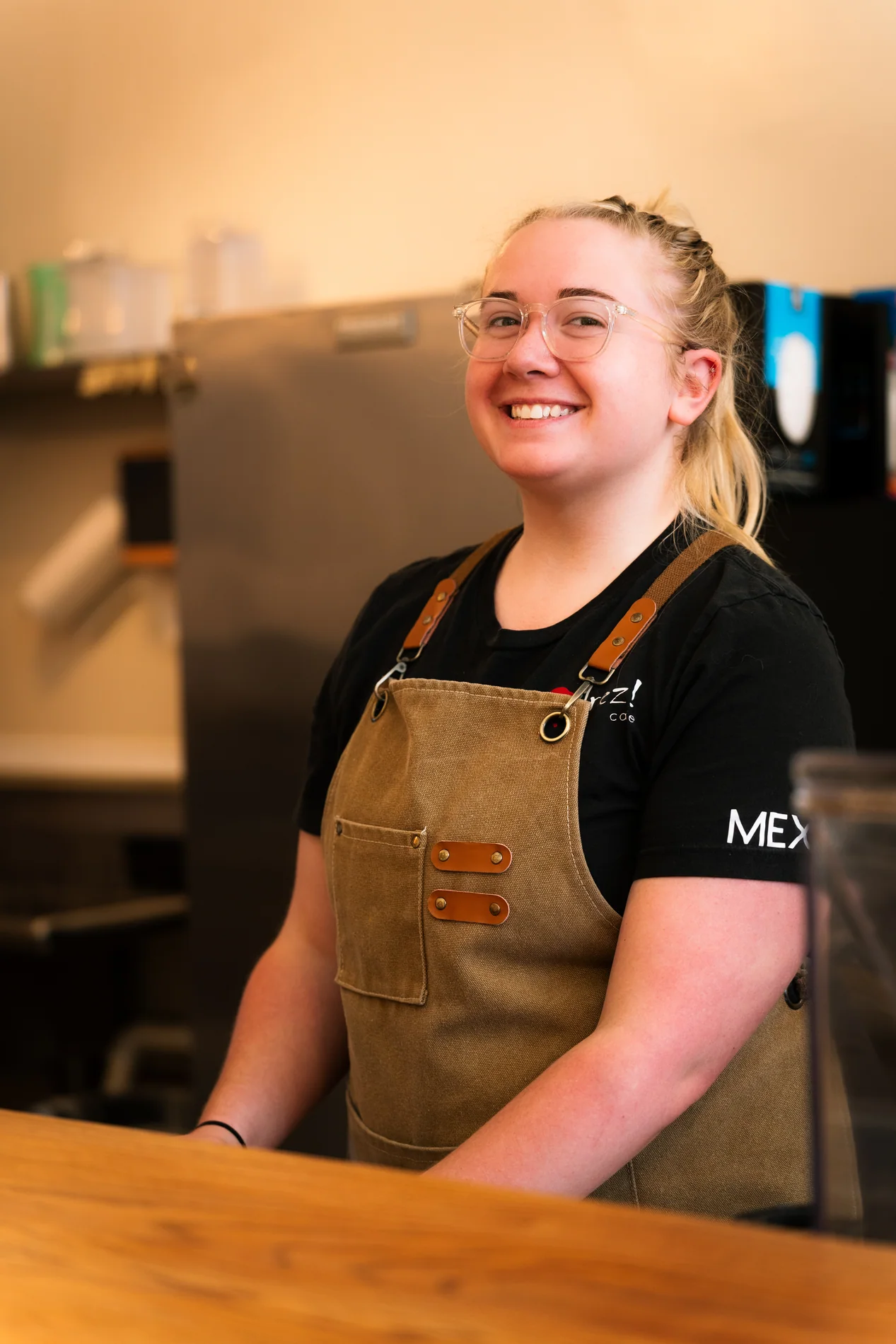 Smiling barista behind the counter